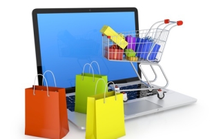 Laptop with shopping bags, shopping cart, and gift boxes isolated on white. Electronic commerce concept.